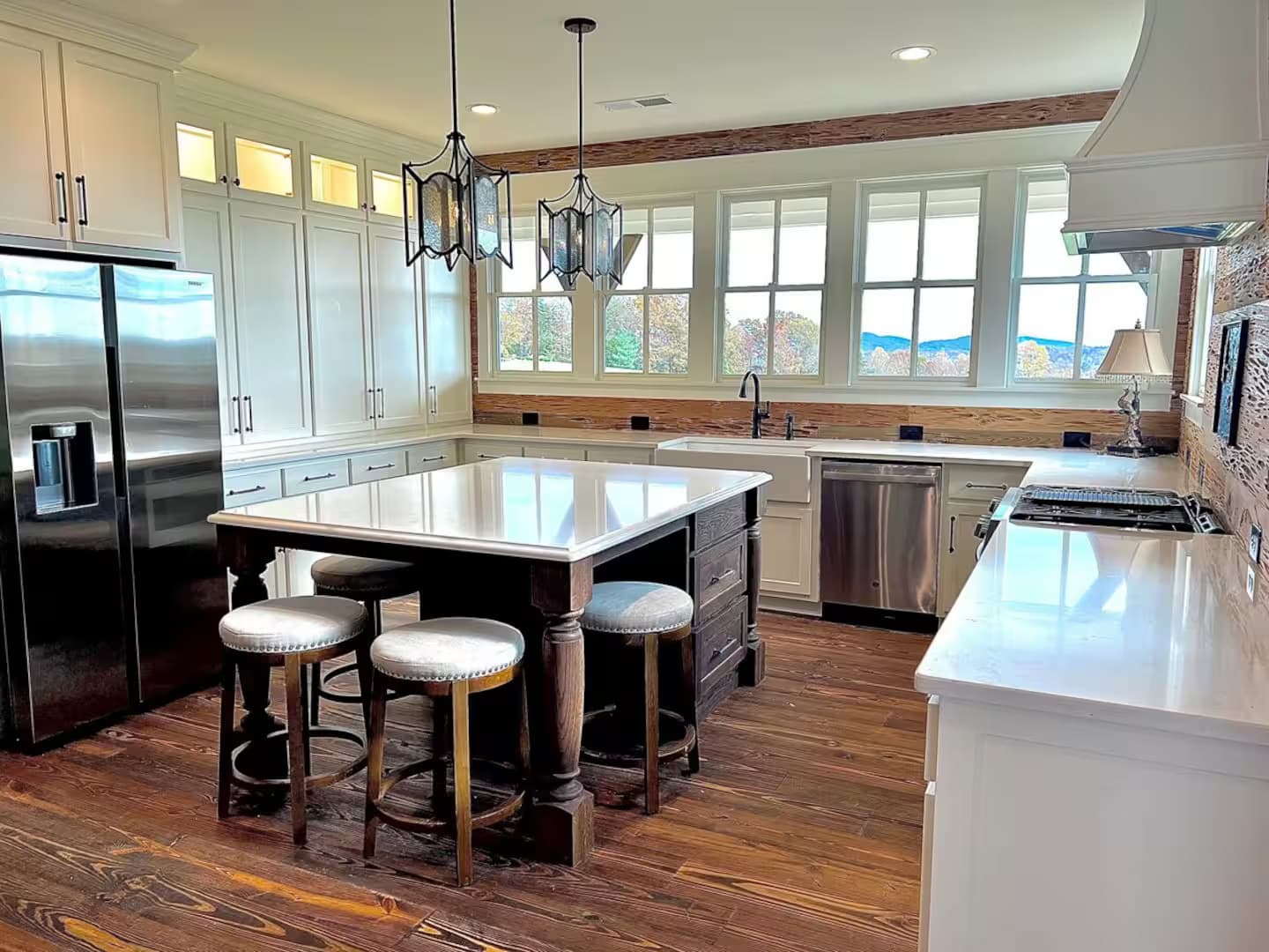 Large kitchen with white cabinets, large center island and Becky cypress walls
