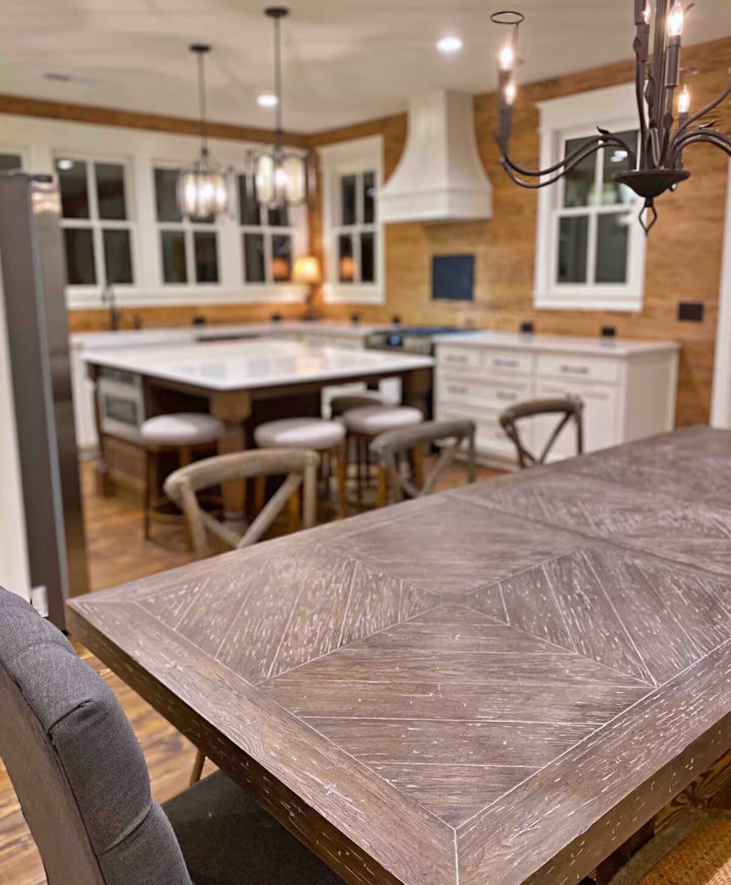 View of kitchen from the dining room with table that seats 10