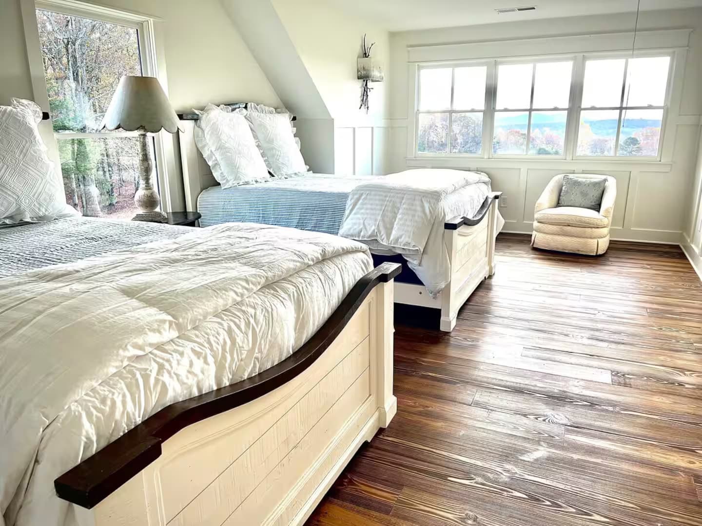 Bedroom with 2 queen beds, wood flooring and a view of them mountains