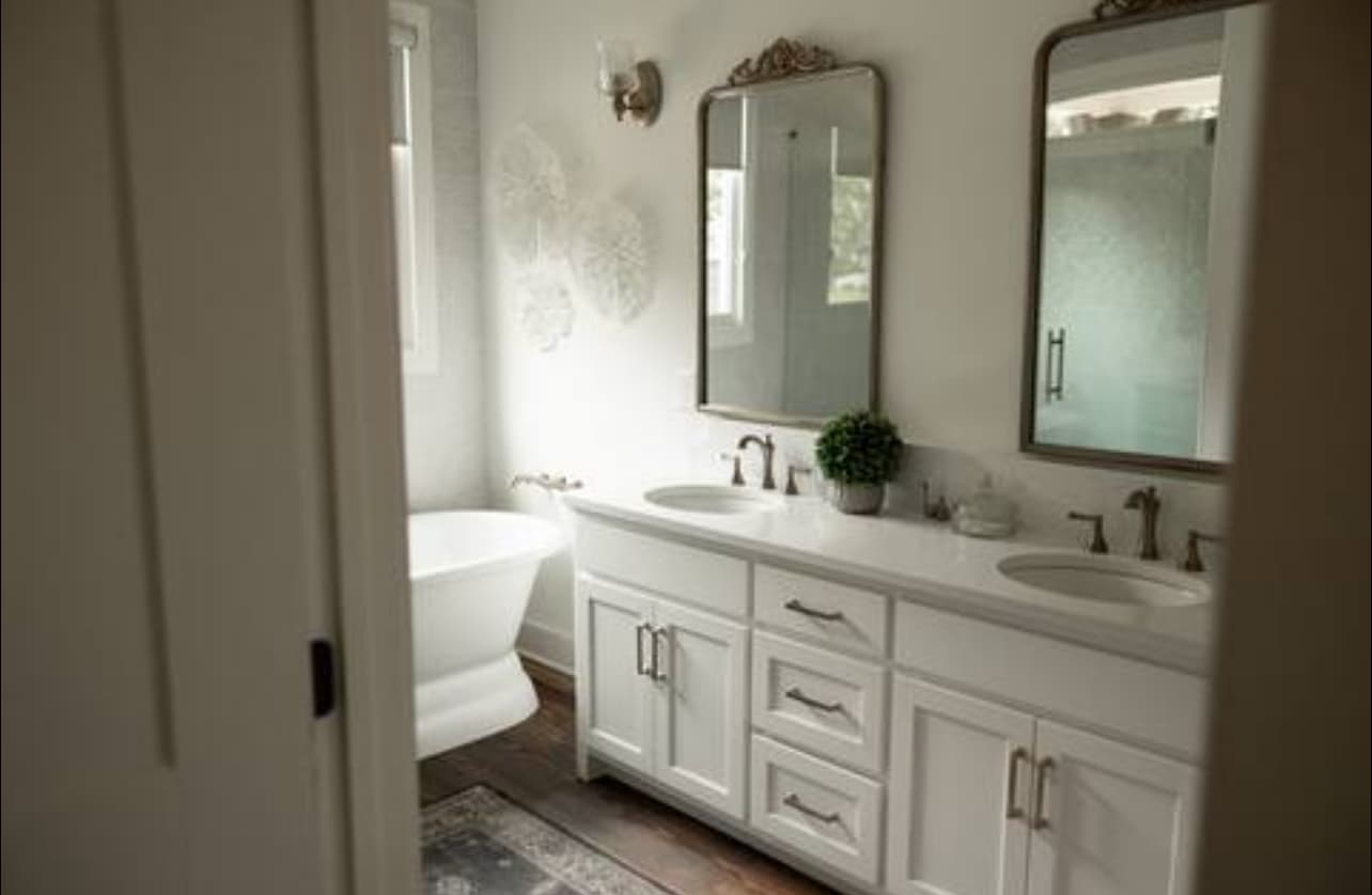Bathroom with white cabinets, large shower and freestanding tub