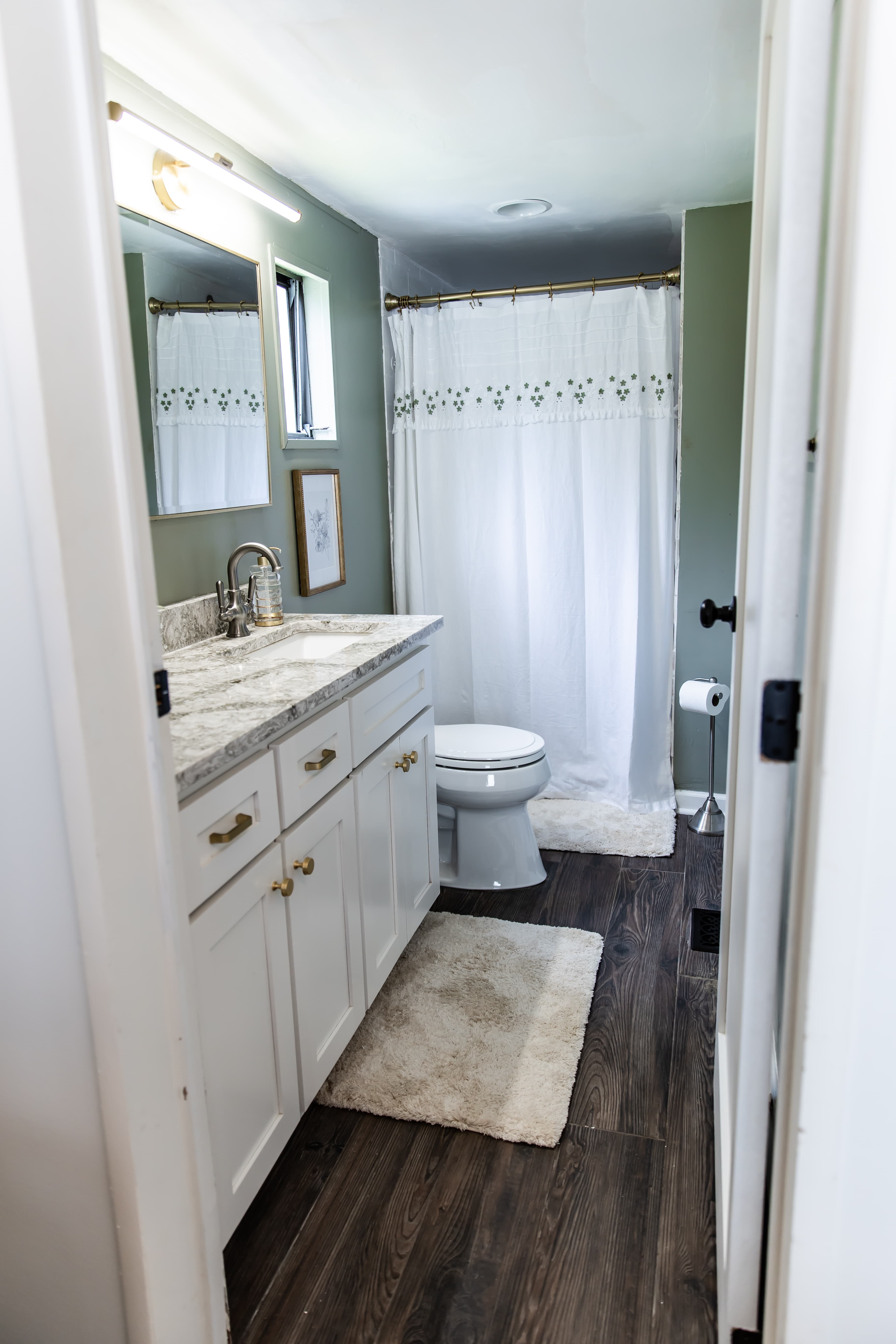 Master Bath with white vanity and tiled shower